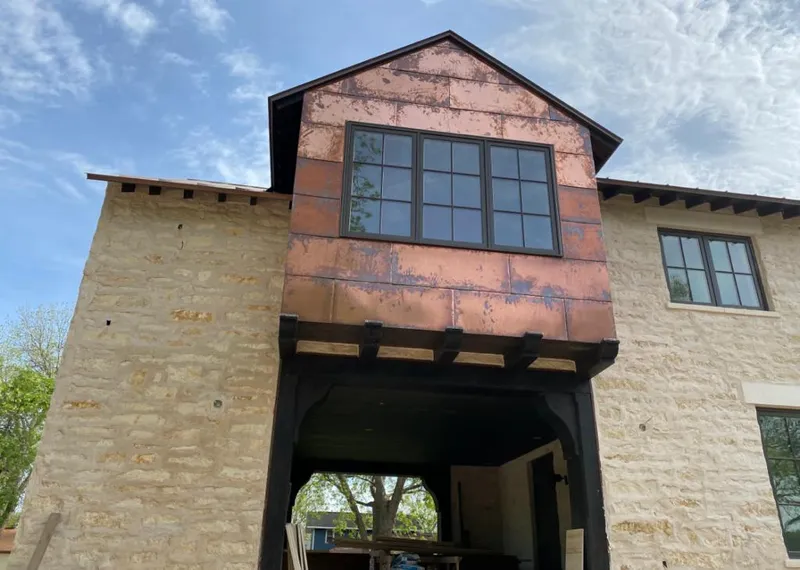 Copper metal panel facade on a stone building for Skylight Installation in Dahlonega