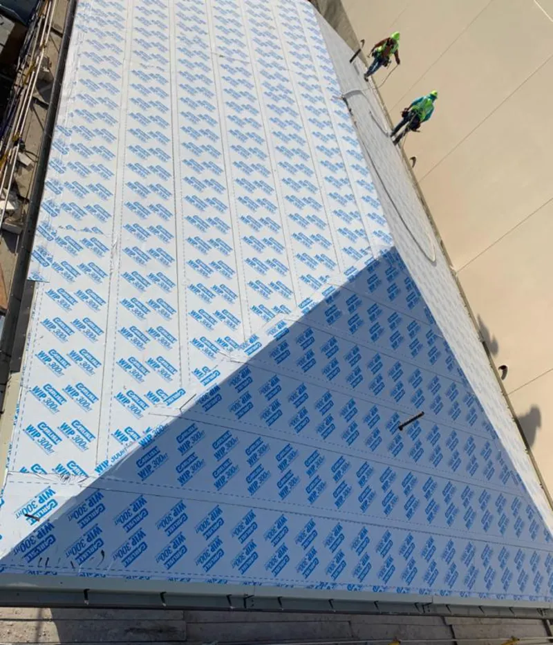 Professional roofers installing underlayment on a metal roof in Dahlonega